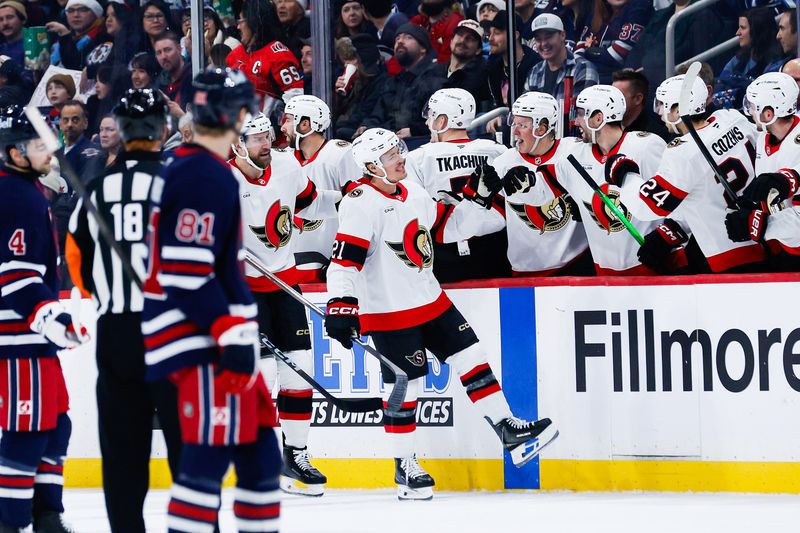 Dec 15, 2025; Winnipeg, Manitoba, CAN;  Ottawa Senators forward Nick Cousins (21) is congratulated by his teammates on his goal against the Winnipeg Jets during the second period at Canada Life Centre. Mandatory Credit: Terrence Lee-Imagn Images