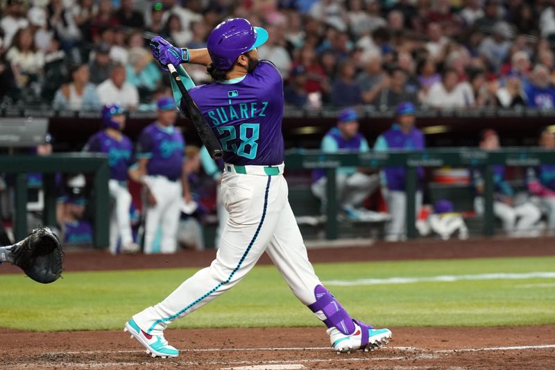 May 10, 2025; Phoenix, Arizona, USA; Arizona Diamondbacks third base Eugenio Suárez (28) hits a solo home run against the Los Angeles Dodgers during the sixth inning at Chase Field. Mandatory Credit: Joe Camporeale-Imagn Images