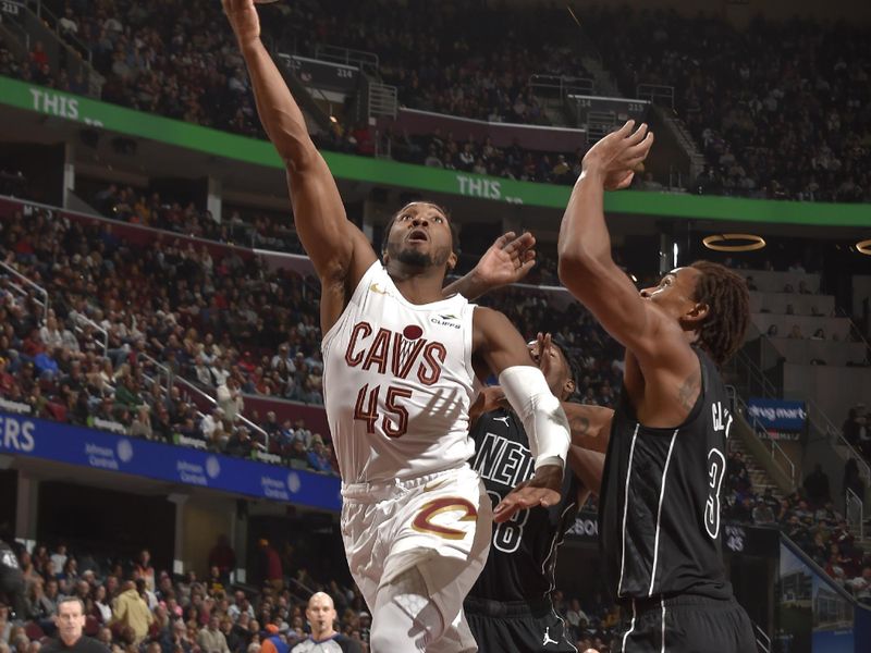 CLEVELAND, OH - NOVEMBER 9: Donovan Mitchell #45 of the Cleveland Cavaliers drives to the basket during the game against the Brooklyn Nets on November 9, 2024 at Rocket Mortgage FieldHouse in Cleveland, Ohio. NOTE TO USER: User expressly acknowledges and agrees that, by downloading and/or using this Photograph, user is consenting to the terms and conditions of the Getty Images License Agreement. Mandatory Copyright Notice: Copyright 2024 NBAE (Photo by David Liam Kyle/NBAE via Getty Images)