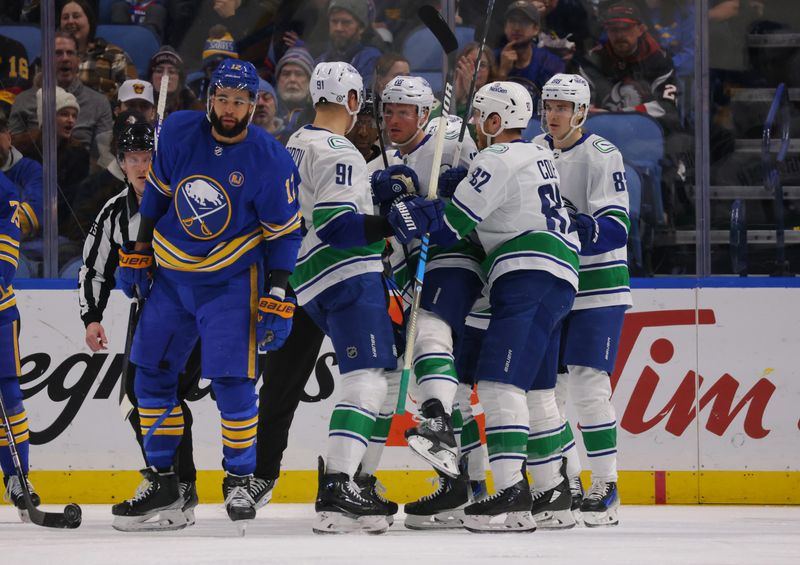 Jan 13, 2024; Buffalo, New York, USA;  Vancouver Canucks center Sam Lafferty (18) celebrates his goal with teammates during the second period against the Buffalo Sabres at KeyBank Center. Mandatory Credit: Timothy T. Ludwig-USA TODAY Sports