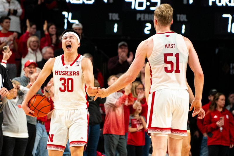 Jan 9, 2024; Lincoln, Nebraska, USA; Nebraska Cornhuskers guard Keisei Tominaga (30) and forward Rienk Mast (51) celebrate at the end of the game against the Purdue Boilermakers at Pinnacle Bank Arena. Mandatory Credit: Dylan Widger-USA TODAY Sports