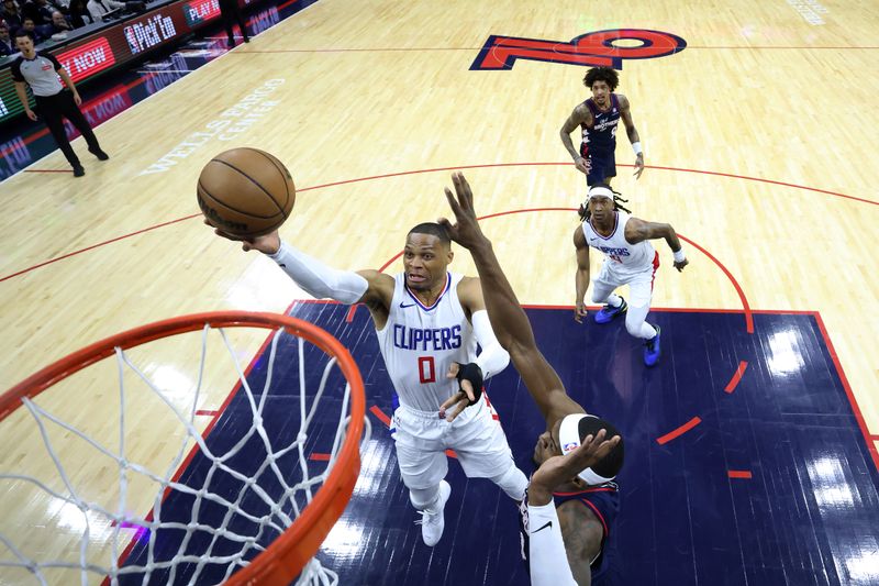 PHILADELPHIA, PENNSYLVANIA - MARCH 27: Russell Westbrook #0 of the LA Clippers shoots a lay up past Paul Reed #44 of the Philadelphia 76ers during the first quarter  at the Wells Fargo Center on March 27, 2024 in Philadelphia, Pennsylvania. NOTE TO USER: User expressly acknowledges and agrees that, by downloading and or using this photograph, User is consenting to the terms and conditions of the Getty Images License Agreement. (Photo by Tim Nwachukwu/Getty Images)