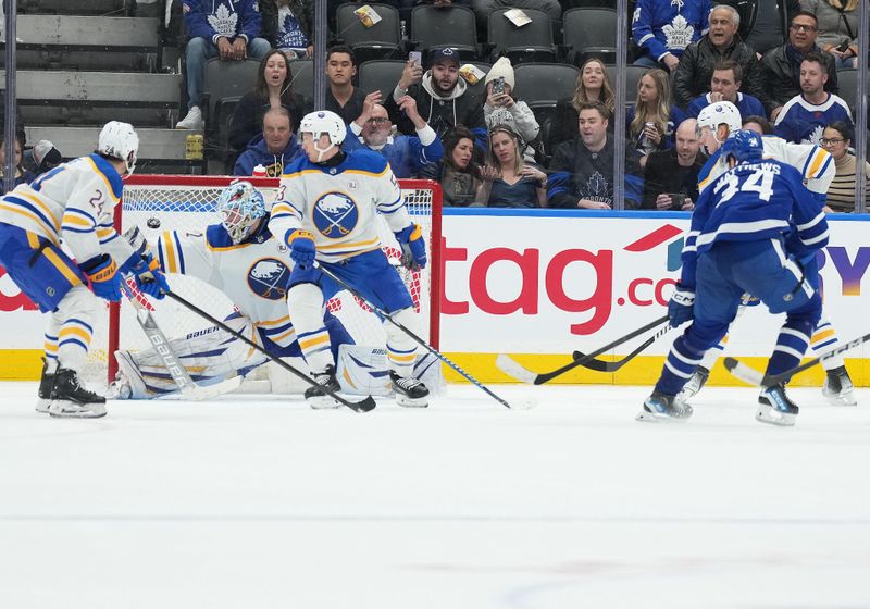 Mar 6, 2024; Toronto, Ontario, CAN; Toronto Maple Leafs center Auston Matthews (34) scores the winning goal against the Buffalo Sabres during the overtime period at Scotiabank Arena. Mandatory Credit: Nick Turchiaro-USA TODAY Sports