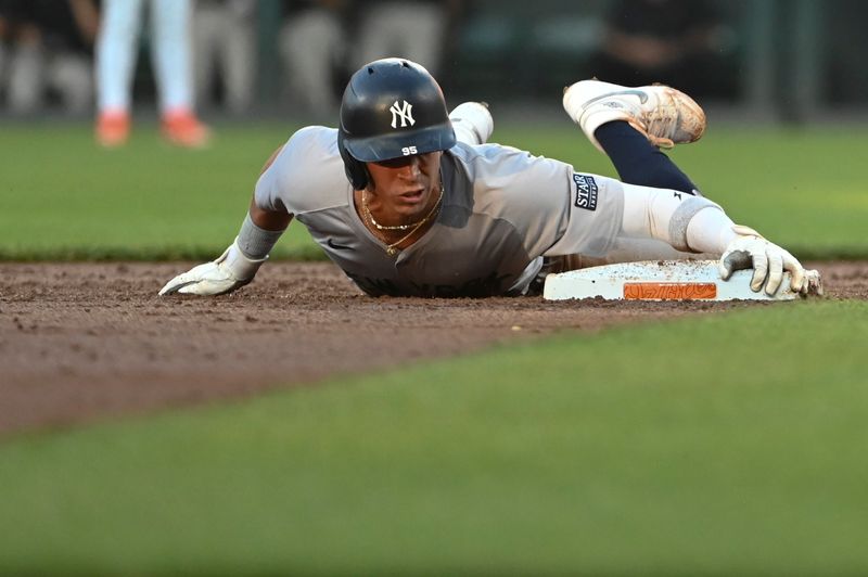 May 1, 2024; Baltimore, Maryland, USA;  New York Yankees third baseman Oswaldo Cabrera (95) holds holds onto second base after stealing during the third inning against the New York Yankees at Oriole Park at Camden Yards. Mandatory Credit: Tommy Gilligan-USA TODAY Sports