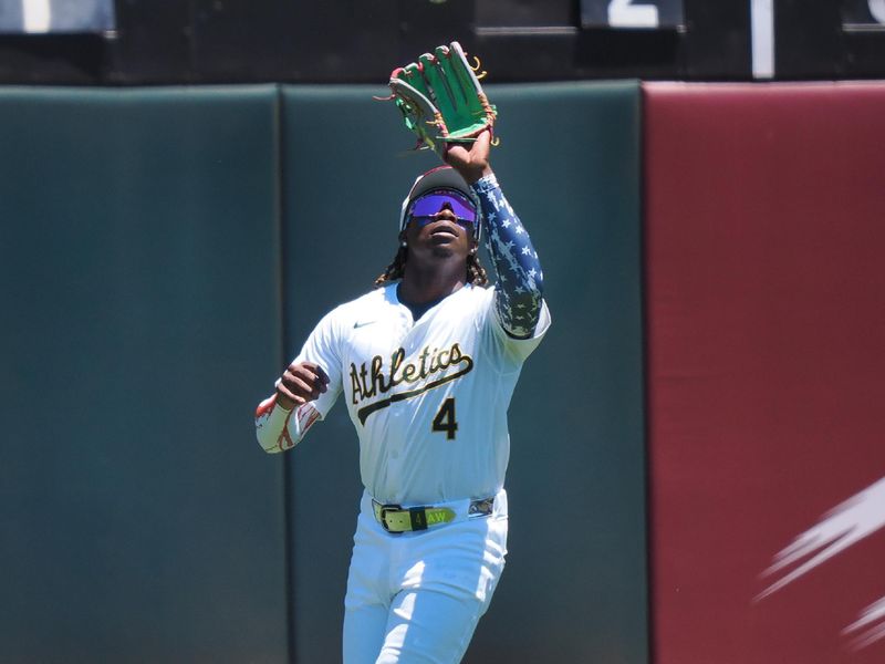 Jul 4, 2024; Oakland, California, USA; Oakland Athletics right fielder Lawrence Butler (4) catches the ball against the Los Angeles Angels during the third inning at Oakland-Alameda County Coliseum. Mandatory Credit: Kelley L Cox-USA TODAY Sports