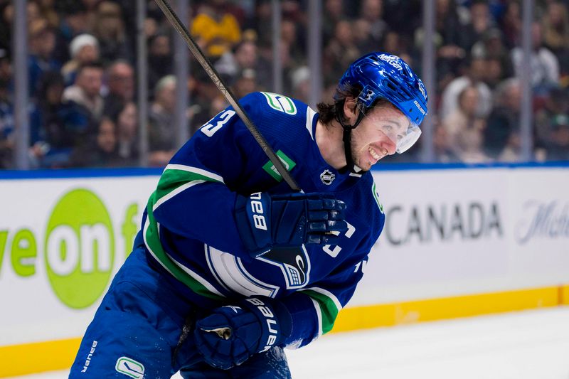 Jan 24, 2024; Vancouver, British Columbia, CAN; Vancouver Canucks defenseman Quinn Hughes (43) reacts after being checked into the end boards by St. Louis Blues forward Oskar Sundqvist (70) in the third period at Rogers Arena. Blues 4-3 in overtime. Mandatory Credit: Bob Frid-USA TODAY Sports