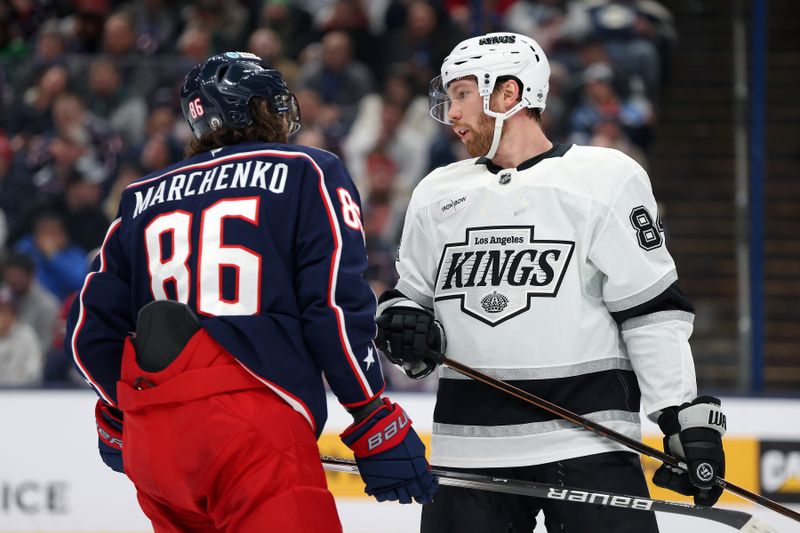 Jan 25, 2025; Columbus, Ohio, USA; Columbus Blue Jackets right wing Kirill Marchenko (86) and Los Angeles Kings defenseman Vladislav Gavrikov (84) exchange words during the second period at Nationwide Arena. Mandatory Credit: Joseph Maiorana-Imagn Images