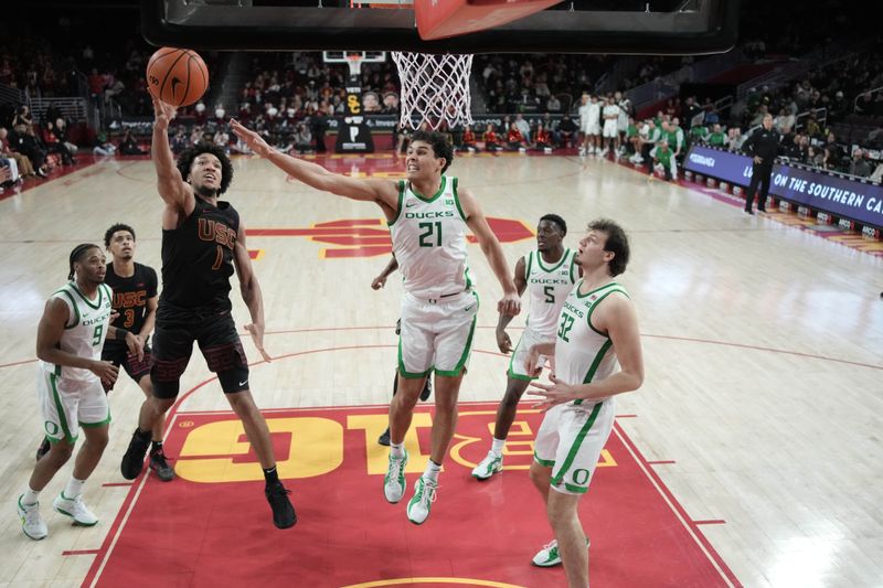 Dec 4, 2024; Los Angeles, California, USA; Southern California Trojans guard Desmond Claude (1) shoots the ball against Oregon Ducks forward Brandon Angel (21) in the second half at Galen Center. Mandatory Credit: Kirby Lee-Imagn ImagesDec 4, 2024; Los Angeles, California, USA; at Galen Center. Mandatory Credit: Kirby Lee-Imagn Images