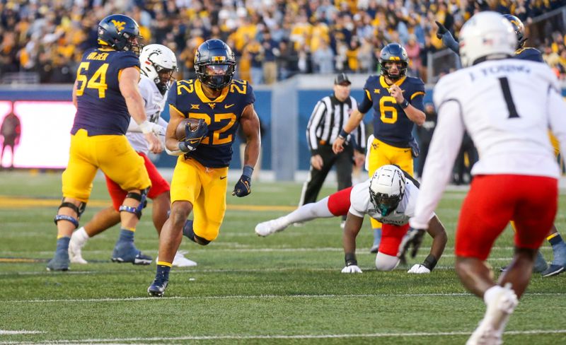 Nov 18, 2023; Morgantown, West Virginia, USA; West Virginia Mountaineers running back Jahiem White (22) runs the ball during the third quarter against the Cincinnati Bearcats at Mountaineer Field at Milan Puskar Stadium. Mandatory Credit: Ben Queen-USA TODAY Sports