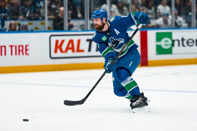 Jan 27, 2026; Vancouver, British Columbia, CAN; Vancouver Canucks defenseman Filip Hronek (17) shoots against the San Jose Sharks in the second period at Rogers Arena. Mandatory Credit: Bob Frid-Imagn Images