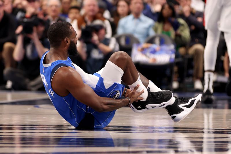 DALLAS, TEXAS - JANUARY 05: Tim Hardaway Jr. #10 of the Dallas Mavericks grabs his ankle in the first half against the Portland Trail Blazers at American Airlines Center on January 05, 2024 in Dallas, Texas. NOTE TO USER: User expressly acknowledges and agrees that, by downloading and or using this photograph, User is consenting to the terms and conditions of the Getty Images License Agreement. (Photo by Tim Heitman/Getty Images)