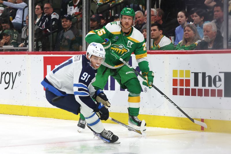 Apr 6, 2024; Saint Paul, Minnesota, USA; Winnipeg Jets center Cole Perfetti (91) watches the puck leave the zone with Minnesota Wild defenseman Jonas Brodin (25) during the third period at Xcel Energy Center. Winnipeg won 4-2. Mandatory Credit: Bruce Fedyck-USA TODAY Sports