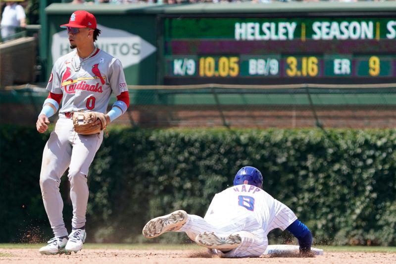 Jun 16, 2024; Chicago, Illinois, USA; Chicago Cubs outfielder Ian Happ (8) steals second base as St. Louis Cardinals shortstop Masyn Winn (0) stands nearby at Wrigley Field. Mandatory Credit: David Banks-USA TODAY Sports