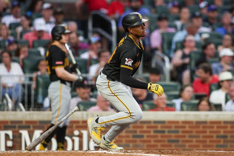 Jun 28, 2024; Atlanta, Georgia, USA; Pittsburgh Pirates third baseman Ke'Bryan Hayes (13) hits a single against the Atlanta Braves in the fifth inning at Truist Park. Mandatory Credit: Brett Davis-USA TODAY Sports