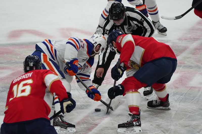 Jun 9, 2025; Sunrise, Florida, USA; Edmonton Oilers center Connor McDavid (97) and Florida Panthers forward Sam Reinhart (13) faceoff during the first period in game three of the 2025 Stanley Cup Final at Amerant Bank Arena. Mandatory Credit: Jim Rassol-Imagn Images