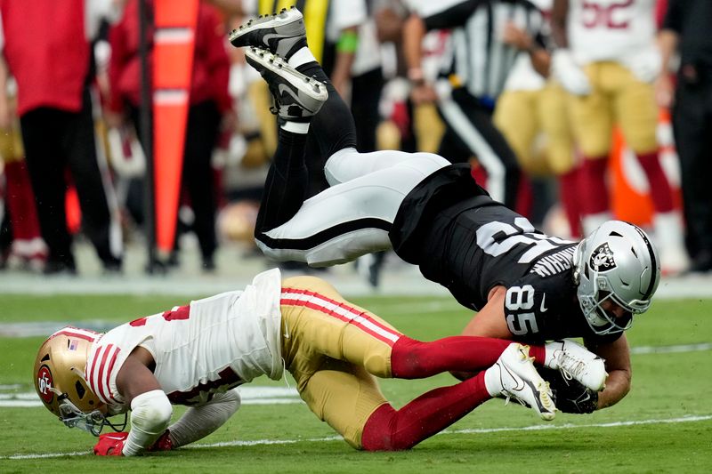 Las Vegas Raiders tight end Cole Fotheringham (85) is hit by San Francisco 49ers safety Ji'Ayir Brown during the first half of an NFL preseason football game, Sunday, Aug. 13, 2023, in Las Vegas. (AP Photo/John Locher)