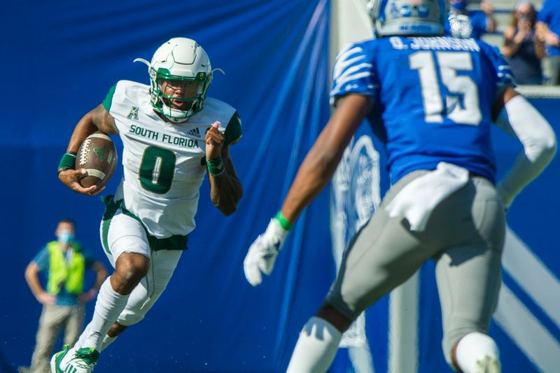 Nov 7, 2020; Memphis, Tennessee, USA; South Florida Bulls quarterback Noah Johnson (0) carries the ball against Memphis Tigers defensive back Quindell Johnson (15) during the first half  at Liberty Bowl Memorial Stadium. Mandatory Credit: Justin Ford-USA TODAY Sports