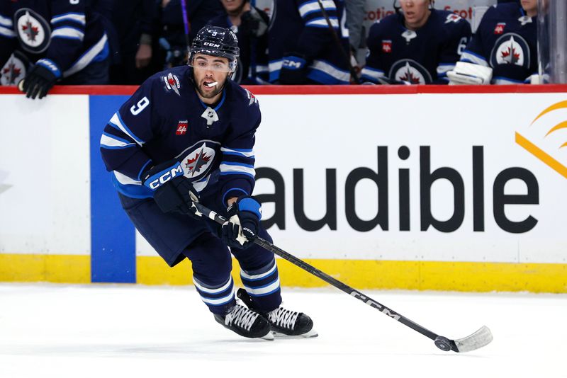 Apr 7, 2025; Winnipeg, Manitoba, CAN; Winnipeg Jets left wing Alex Iafallo (9) skates with the puck against the St. Louis Blues in the first period at Canada Life Centre. Mandatory Credit: James Carey Lauder-Imagn Images