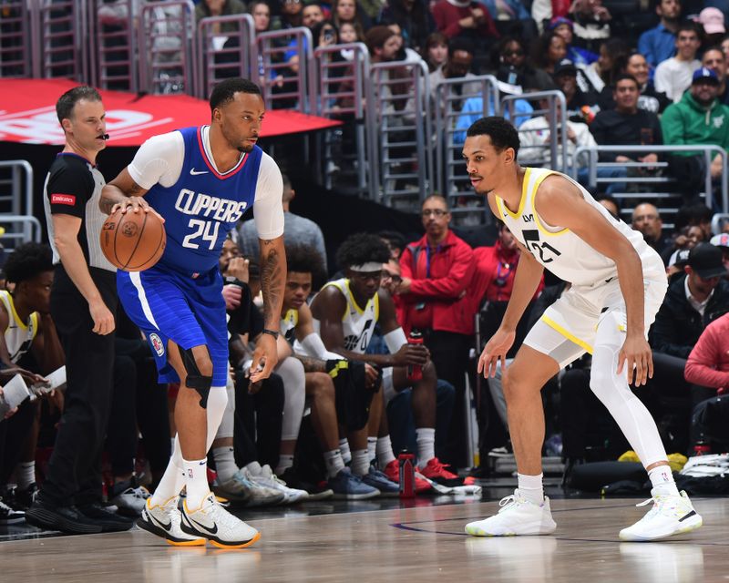 LOS ANGELES, CA - APRIL 5:  Darius Bazley #21 of the Utah Jazz plays defense during the game  against Norman Powell #24 of the LA Clippers on April 5, 2024 at Crypto.Com Arena in Los Angeles, California. NOTE TO USER: User expressly acknowledges and agrees that, by downloading and/or using this Photograph, user is consenting to the terms and conditions of the Getty Images License Agreement. Mandatory Copyright Notice: Copyright 2024 NBAE (Photo by Adam Pantozzi/NBAE via Getty Images)