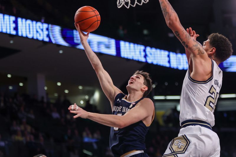 Feb 8, 2023; Atlanta, Georgia, USA; Notre Dame Fighting Irish guard Cormac Ryan (5) shoots past Georgia Tech Yellow Jackets center Rodney Howard (24) in the first half at McCamish Pavilion. Mandatory Credit: Brett Davis-USA TODAY Sports