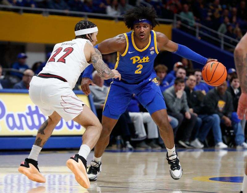 Feb 17, 2024; Pittsburgh, Pennsylvania, USA;  Pittsburgh Panthers forward Blake Hinson (2) handles the ball against Louisville Cardinals guard Tre White (22) during the first half at the Petersen Events Center. Mandatory Credit: Charles LeClaire-USA TODAY Sports