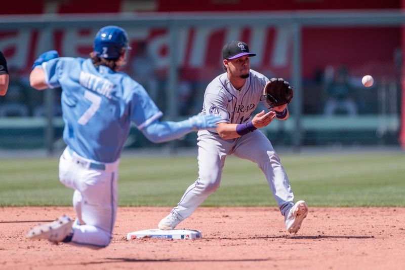 Jun 3, 2023; Kansas City, Missouri, USA;  Colorado Rockies shortstop Ezequiel Tovar (14) reaches for a throw ahead of Kansas City Royals shortstop Bobby Witt Jr. (7) sliding into second base during the first inning at Kauffman Stadium. Mandatory Credit: William Purnell-USA TODAY Sports