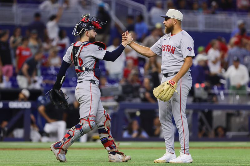 Jul 4, 2024; Miami, Florida, USA; Boston Red Sox catcher Connor Wong (12) celebrates with relief pitcher Greg Weissert (57) after the game against the Miami Marlins at loanDepot Park. Mandatory Credit: Sam Navarro-USA TODAY Sports