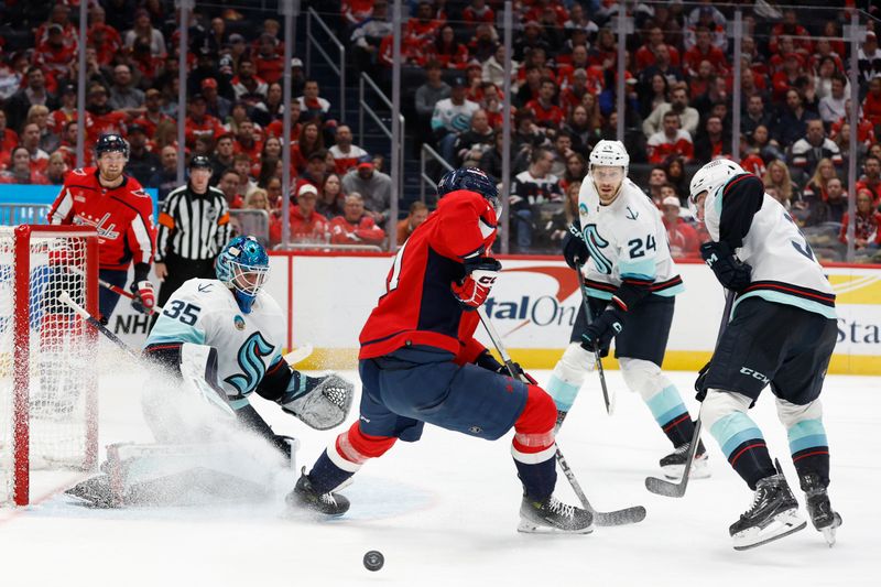 Jan 11, 2024; Washington, District of Columbia, USA; Seattle Kraken goaltender Joey Daccord (35) makes a save on Washington Capitals center Aliaksei Protas (21) in the third period at Capital One Arena. Mandatory Credit: Geoff Burke-USA TODAY Sports