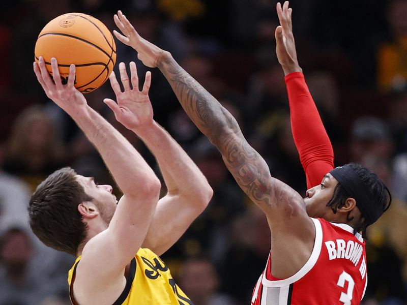 Mar 9, 2023; Chicago, IL, USA; Iowa Hawkeyes forward Filip Rebraca (0) shoots against Ohio State Buckeyes guard Eugene Brown III (3) during the first half at United Center. Mandatory Credit: Kamil Krzaczynski-USA TODAY Sports