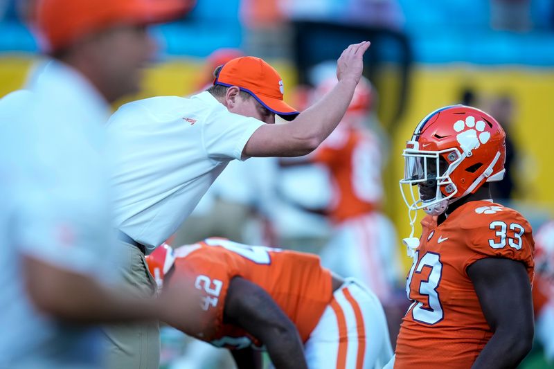 Sep 4, 2021; Charlotte, North Carolina, USA; Clemson Tigers head coach Dabo Swinney peps up a player at warmups during the first quarter against the Georgia Bulldogs at Bank of America Stadium. Mandatory Credit: Jim Dedmon-USA TODAY Sports