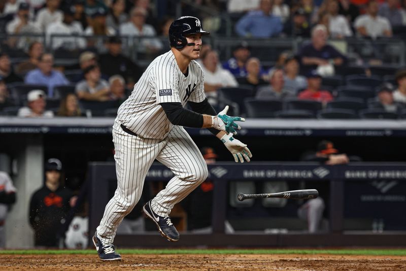 Sep 26, 2024; Bronx, New York, USA; New York Yankees first baseman Anthony Rizzo (48) hits a two RBI single during the sixth inning against the Baltimore Orioles at Yankee Stadium. Mandatory Credit: Vincent Carchietta-Imagn Images