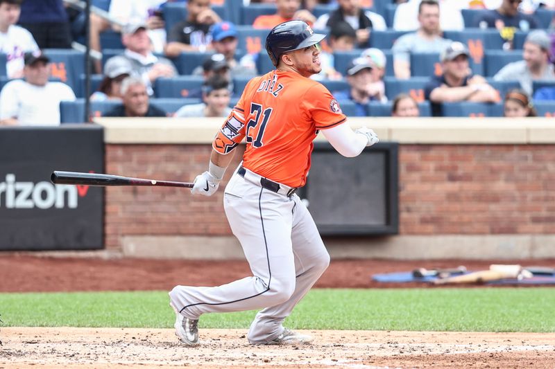 Jun 30, 2024; New York City, New York, USA;  Houston Astros catcher Yainer Diaz (21) hits an RBI single in the fourth inning against the New York Mets at Citi Field. Mandatory Credit: Wendell Cruz-USA TODAY Sports