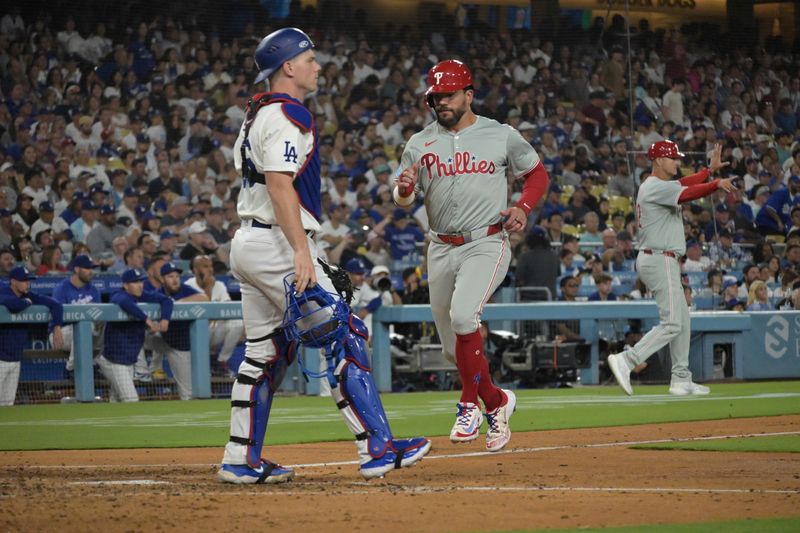 Aug 5, 2024; Los Angeles, California, USA;  Philadelphia Phillies designated hitter Kyle Schwarber (12) crosses the plate for a run in the sixth inning against the Los Angeles Dodgers at Dodger Stadium. Mandatory Credit: Jayne Kamin-Oncea-USA TODAY Sports