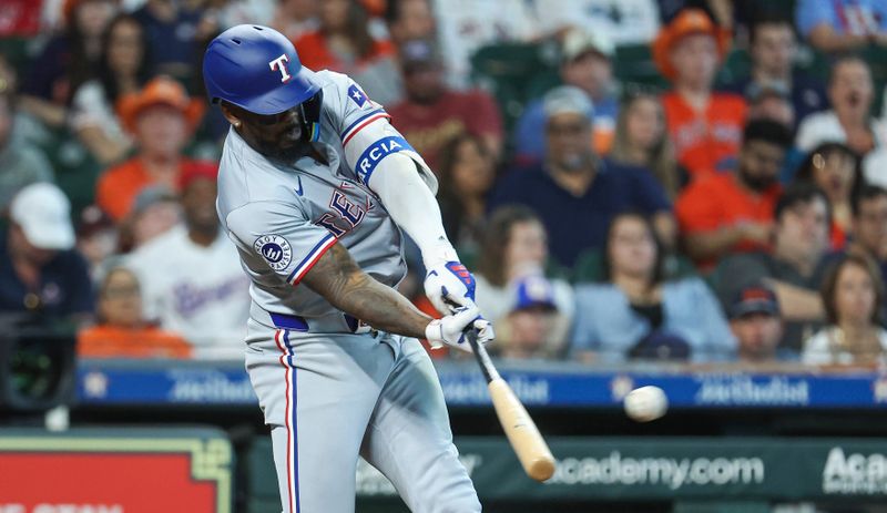 Apr 14, 2024; Houston, Texas, USA; Texas Rangers right fielder Adolis Garcia (53) hits a single during the eighth inning against the Houston Astros at Minute Maid Park. Mandatory Credit: Troy Taormina-USA TODAY Sports