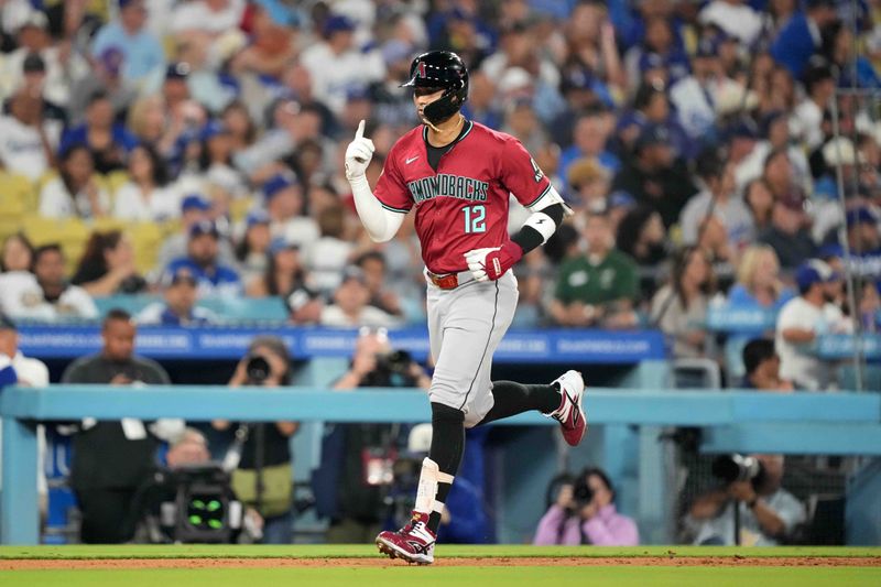 Jul 3, 2024; Los Angeles, California, USA; Arizona Diamondbacks left fielder Lourdes Gurriel Jr. (12) celebrates after hitting a two-run home run in the sixth inning against the Los Angeles Dodgers at Dodger Stadium. Mandatory Credit: Kirby Lee-USA TODAY Sports