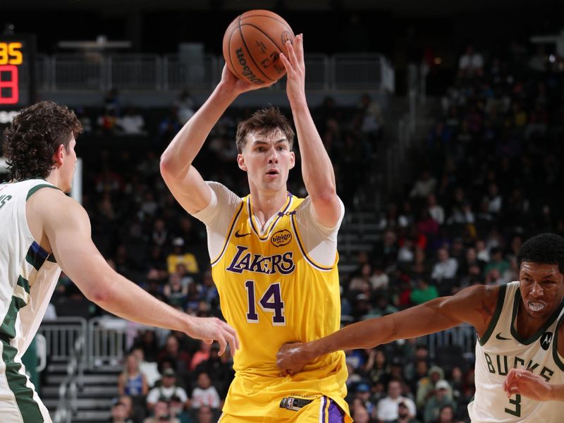 MILWAUKEE, WI - OCTOBER 10: Colin Castleton #14 of the Los Angeles Lakers looks to pass the ball during the game against the Milwaukee Bucks during a preseason game on October 10, 2024 at Fiserv Forum Center in Milwaukee, Wisconsin. NOTE TO USER: User expressly acknowledges and agrees that, by downloading and or using this Photograph, user is consenting to the terms and conditions of the Getty Images License Agreement. Mandatory Copyright Notice: Copyright 2024 NBAE (Photo by Gary Dineen/NBAE via Getty Images).