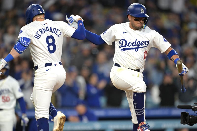 May 20, 2024; Los Angeles, California, USA;  Los Angeles Dodgers third baseman Kiki Hernandez (8) is congratulated by second baseman Miguel Rojas (11) after hitting a solo home run in the third inning against the Arizona Diamondbacks at Dodger Stadium. Mandatory Credit: Jayne Kamin-Oncea-USA TODAY Sports