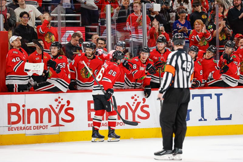 Mar 9, 2026; Chicago, Illinois, USA; Chicago Blackhawks left wing Andrew Mangiapane (26) celebrates with teammates after scoring against the Utah Mammoth during the first period at United Center. Mandatory Credit: Kamil Krzaczynski-Imagn Images