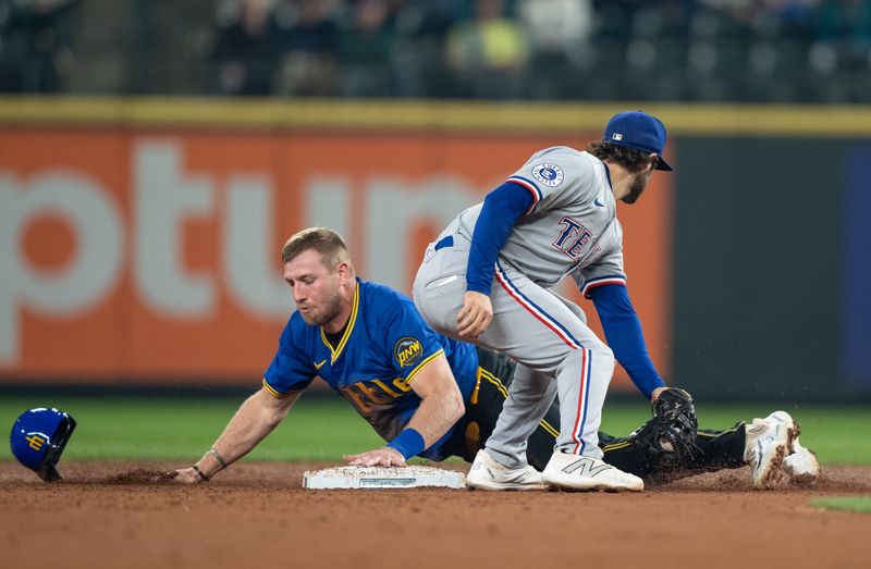 Sep 13, 2024; Seattle, Washington, USA;  Seattle Mariners first baseman Luke Raley (20) steals second base ahead of a tag by Texas Rangers shortstop Josh Smith (8) during the second inning at T-Mobile Park. Mandatory Credit: Stephen Brashear-Imagn Images