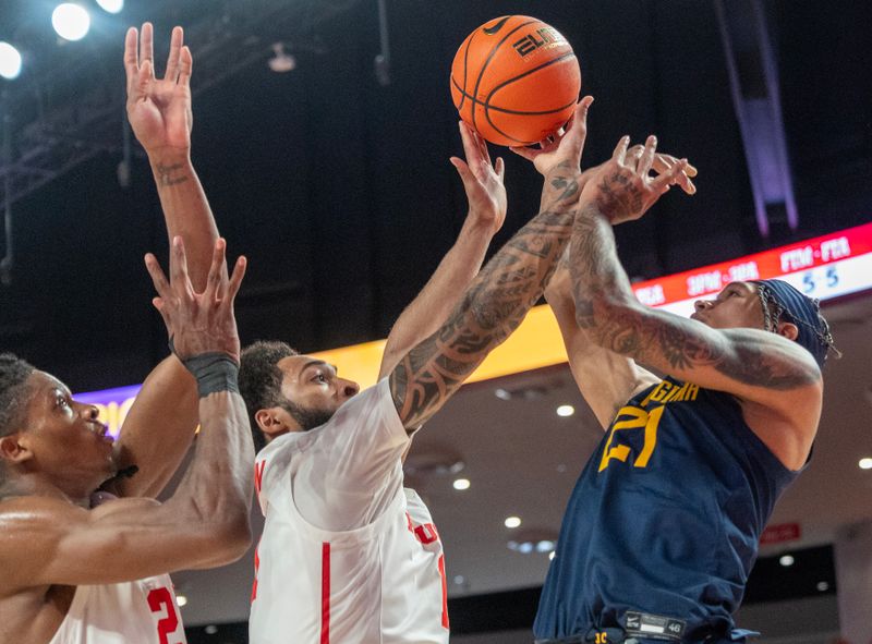 Jan 6, 2024; Houston, Texas, USA;West Virginia Mountaineers guard RaeQuan Battle (21) shoots against Houston Cougars guard Jamal Shead (1) in the first half  at Fertitta Center. Mandatory Credit: Thomas Shea-USA TODAY Sports