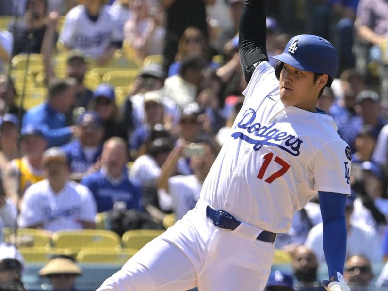 Apr 30, 2025; Los Angeles, California, USA;  Los Angeles Dodgers designated hitter Shohei Ohtani (17) beats the tag by Miami Marlins relief pitcher Luarbert Arias (76) scoring on a wild pitch in the eighth inning at Dodger Stadium. Mandatory Credit: Jayne Kamin-Oncea-Imagn Images