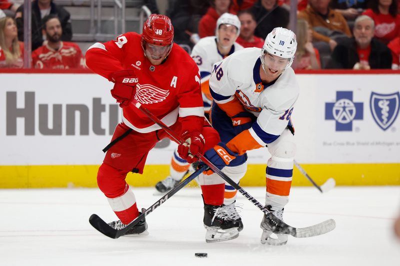 Feb 29, 2024; Detroit, Michigan, USA;  Detroit Red Wings center Andrew Copp (18) and New York Islanders left wing Pierre Engvall (18) battle for the puck in the third period at Little Caesars Arena. Mandatory Credit: Rick Osentoski-USA TODAY Sports