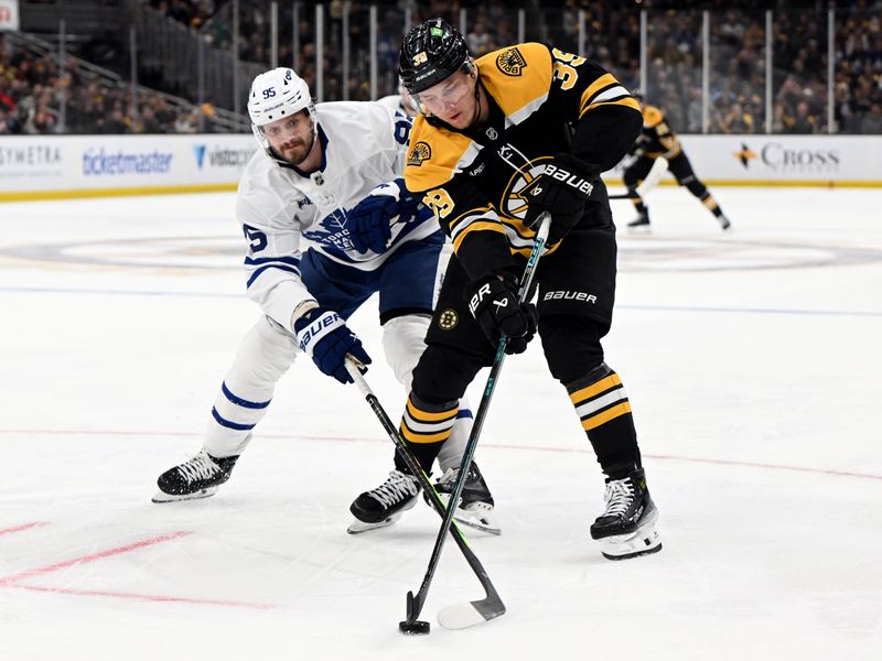 Feb 25, 2025; Boston, Massachusetts, USA; Boston Bruins center Morgan Geekie (39) skates against Toronto Maple Leafs defenseman Oliver Ekman-Larsson (95) during the first period at the TD Garden. Mandatory Credit: Brian Fluharty-Imagn Images