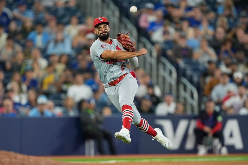 Sep 13, 2024; Toronto, Ontario, CAN; St. Louis Cardinals baseman José Fermín (15) throws out Toronto Blue Jays designated hitter George Springer (not pictured) at first base during the tenth inning at Rogers Centre. Mandatory Credit: John E. Sokolowski-Imagn Images