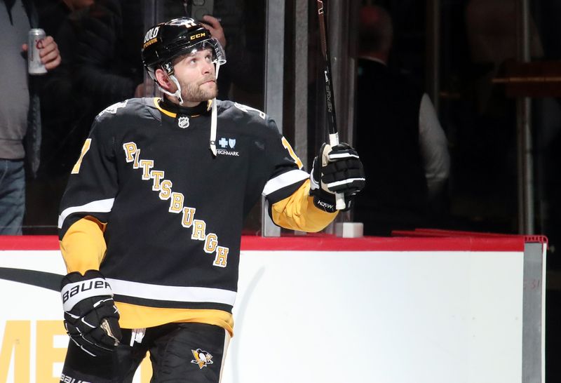 Dec 3, 2024; Pittsburgh, Pennsylvania, USA;  Pittsburgh Penguins right wing Bryan Rust (17) reacts to being named first star of the game against the Florida Panthers at PPG Paints Arena. Mandatory Credit: Charles LeClaire-Imagn Images