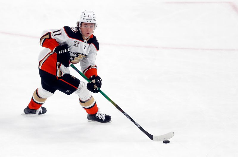 Oct 30, 2023; Pittsburgh, Pennsylvania, USA;  Anaheim Ducks center Trevor Zegras (11) handles the puck against the Pittsburgh Penguins during the second period at PPG Paints Arena. Anaheim won 4-3. Mandatory Credit: Charles LeClaire-USA TODAY Sports