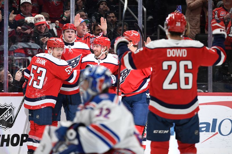 Dec 31, 2025; Washington, District of Columbia, USA; Washington Capitals center Aliaksei Protas (21) celebrates with teammates after scoring a goal against the New York Rangers during the third period at Capital One Arena. Mandatory Credit: Hannah Foslien-Imagn Images
