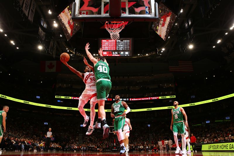 TORONTO, CANADA - OCTOBER 15: Ochai Agbaji #30 of the Toronto Raptors drives to the basket during the game against the Boston Celtics on October 15, 2024 at the Scotiabank Arena in Toronto, Ontario, Canada.  NOTE TO USER: User expressly acknowledges and agrees that, by downloading and or using this Photograph, user is consenting to the terms and conditions of the Getty Images License Agreement.  Mandatory Copyright Notice: Copyright 2024 NBAE (Photo by Vaughn Ridley/NBAE via Getty Images)