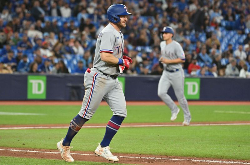 Sep 14, 2023; Toronto, Ontario, CAN;   Texas Rangers right fielder Robbie Grossman (4) moves to first base after a bases loaded walk which drove in shortstop Corey Seager (5) in the eighth inning against the Toronto Blue Jays at Rogers Centre. Mandatory Credit: Dan Hamilton-USA TODAY Sports