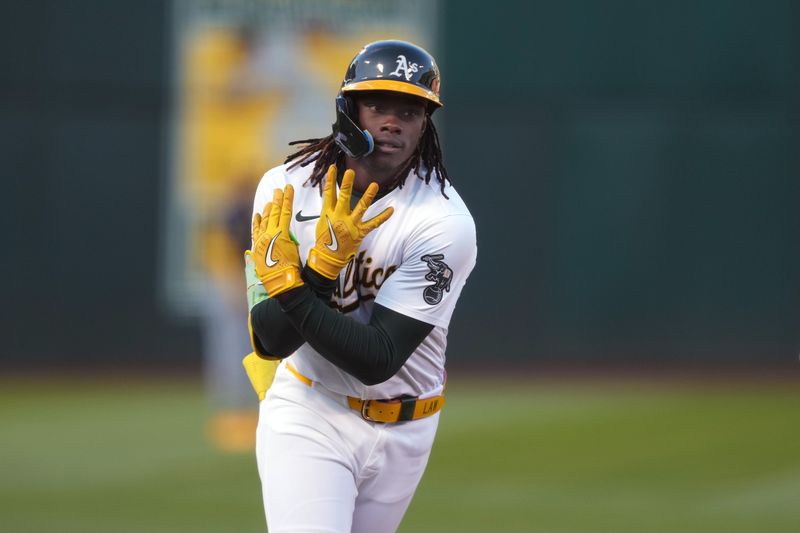 Aug 23, 2024; Oakland, California, USA; Oakland Athletics right fielder Lawrence Butler (4) gestures while rounding the bases after hitting a home run against the Milwaukee Brewers during the first inning at Oakland-Alameda County Coliseum. Mandatory Credit: Darren Yamashita-USA TODAY Sports